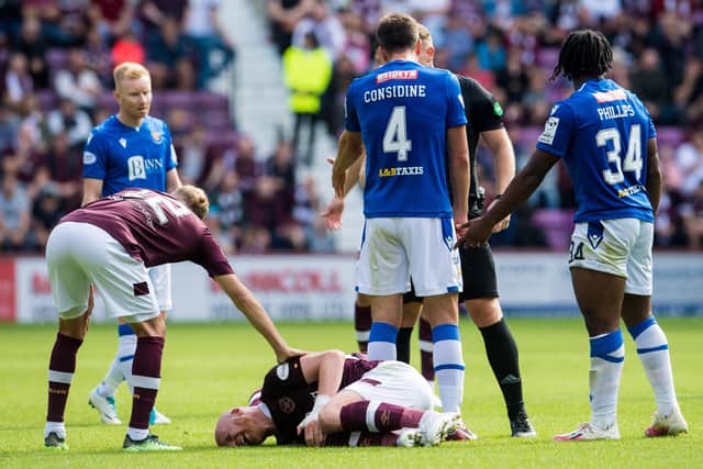 EDINBURGH, SCOTLAND - AUGUST 28: Liam Boyce of Hearts goes down with an injury during a cinch Premiership match between Heart of Midlothian and St Johnstone at Tynecastle Park on August 28, 2022, in Edinburgh, Scotland. (Photo by Ross Parker / SNS Group)