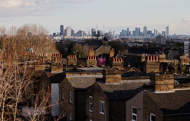A view of the back of residential properties with the skyline of London’s financial district seen behind taken in Walthamstow in London.