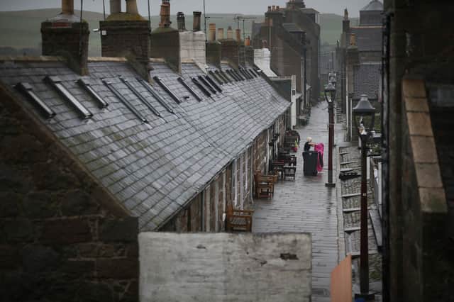  A resident cleans her house in the Footdee area  in Aberdeen, Scotland. 
