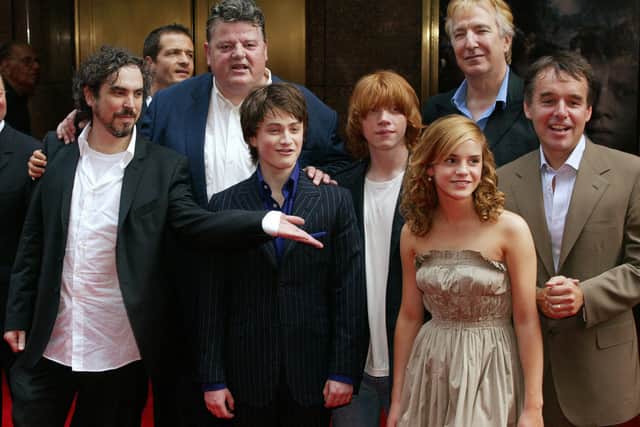 Cast members of Harry Potter & the Prisoner of Azkaban stand together before the preview at Radio City in New York in 2004. From left are: director Alfonso Cuaron, producer David Heyman, Robbie Coltrane, Daniel Radcliffe, Rupert Grint, Emma Watson, Alan Rickman and producer Chris Columbus.