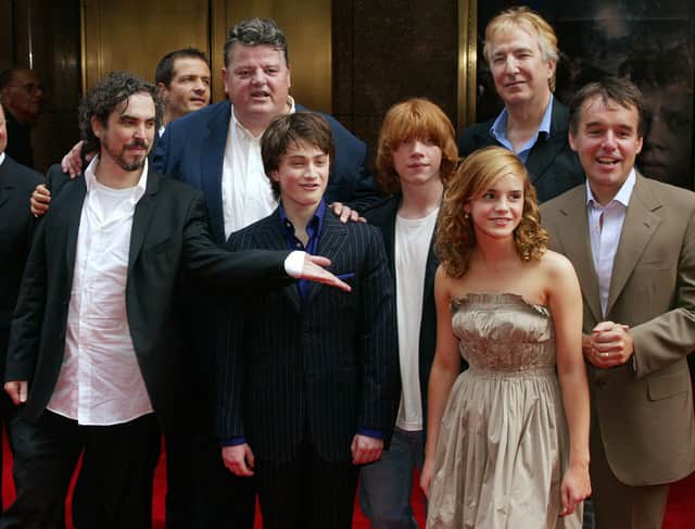 Cast members of Harry Potter & the Prisoner of Azkaban stand together before the preview at Radio City in New York in 2004. From left are: director Alfonso Cuaron, producer David Heyman, Robbie Coltrane, Daniel Radcliffe, Rupert Grint, Emma Watson, Alan Rickman and producer Chris Columbus.