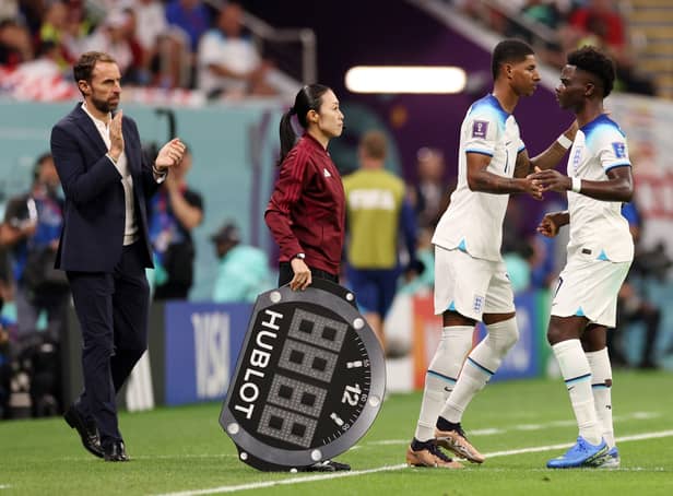 <p>Marcus Rashford and Bukayo Saka of England are substituted during the FIFA World Cup Qatar 2022 Group B match between England and USA at Al Bayt Stadium on November 25, 2022 in Al Khor, Qatar. (Photo by Elsa/Getty Images)</p>