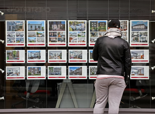 <p>A member of the public looks at residential properties displayed for sale in the window of an estate agents' in London on September 30, 2022. (Photo by ISABEL INFANTES / AFP) (Photo by ISABEL INFANTES/AFP via Getty Images)</p>