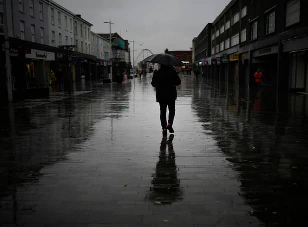 <p>Dismal weather heralds the arrival of the UK Chancellor’s Autumn Statement as people shop in the centre of Bolton.</p>