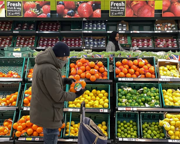 A customer shops for food items inside a Tesco supermarket store in east London on January 10, 2022.  (Photo by DANIEL LEAL/AFP via Getty Images)