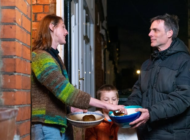 <p>Adam Walters with his son delivering potatoes to one of his neighbours in Lloyds Park, Walthamstow.  </p>