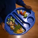 A child carries a tray with food during lunch-break at St Mary’s RC Primary School, in Battersea, south London.