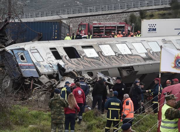 Police and emergency crews search wreckage after a train accident in the Tempi Valley near Larissa, Greece, March 1, 2023. - At least 32 people were killed and another 85 injured after a collision between two trains caused a derailment near the Greek city of Larissa late at night on February 28, 2023, authorities said. A fire services spokesman confirmed that three carriages skipped the tracks just before midnight after the trains -- one for freight and the other carrying 350 passengers - collided about halfway along the route between Athens and Thessaloniki. (Photo by Sakis MITROLIDIS / AFP) (Photo by SAKIS MITROLIDIS/AFP via Getty Images)