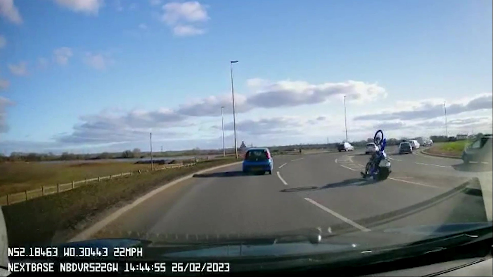 Video: Motorbike rider falls attempting wheelie on roundabout