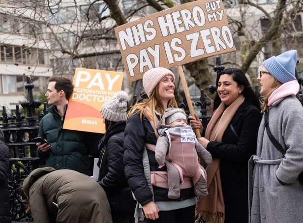 <p>Demonstrators hold placards as they take part in a protest by junior doctors. Picture: NIKLAS HALLE’N/AFP via Getty Images</p>