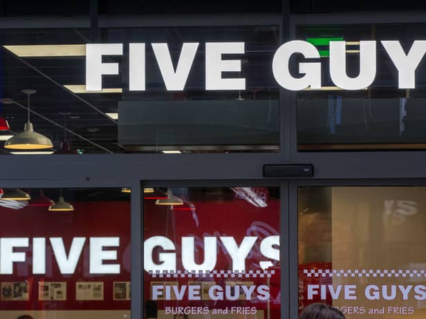 Five Guys reveals why they give customers extra fries & unlimited toppings with every order