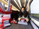 Professional gift wrapper Finn Drumgoole wraps presents for LNER customers to launch the rail operators complimentary Rail Wrapping service (photo: David Parry/PA Wire)