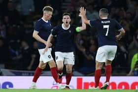 Andy Robertson celebrates as his cross turns into an England own goal by Harry Maguire