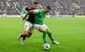 Hearts' Cammy Devlin and Hibs' Lewis Miller tussle for the ball at Tynecastle. Pic: SNS