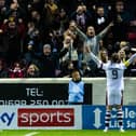 Lawrence Shankland celebrates his second goal with the Hearts fans at Fir Park.