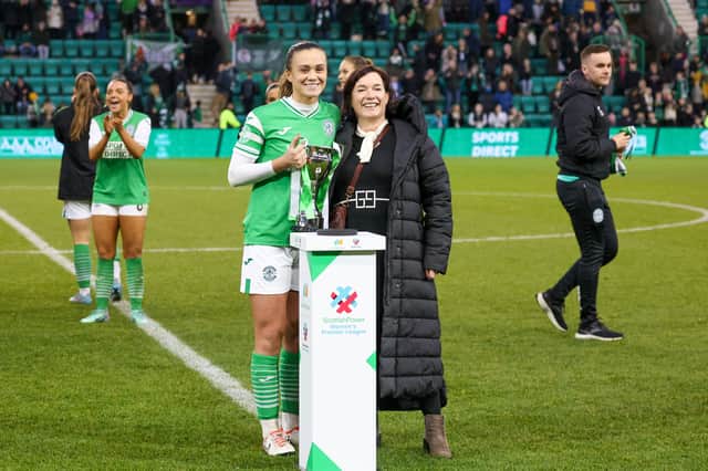 Leah Eddie with the Capital Cup after their victory over Hearts. Credit: David Mollison