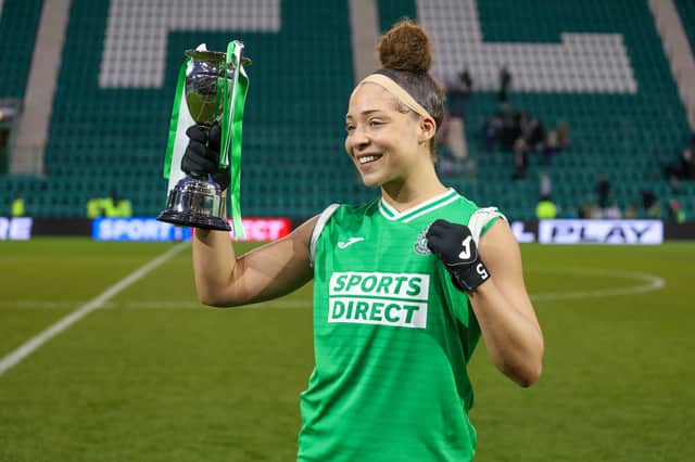Jorian Baucom celebrates with the Capital Cup after overcoming Hearts at Easter Road. Credit: David Mollison