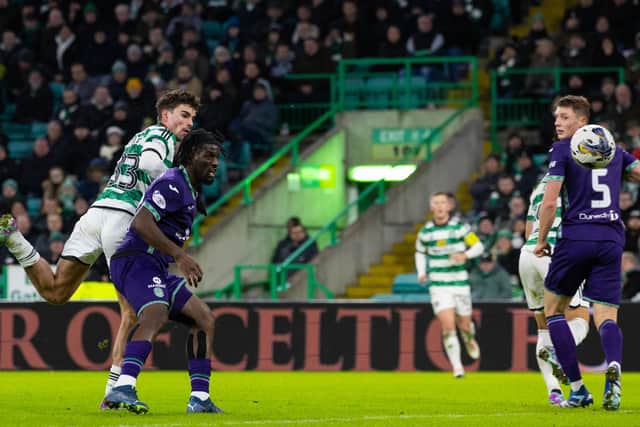 Matt O'Riley gets above Rocky Bushiri to make it 2-0 to Celtic.
