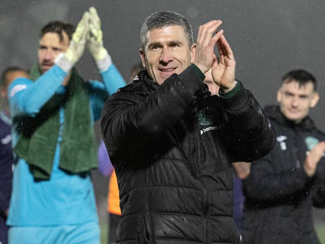 Montgomery and the Hibs players applaud the travelling support at Livingston