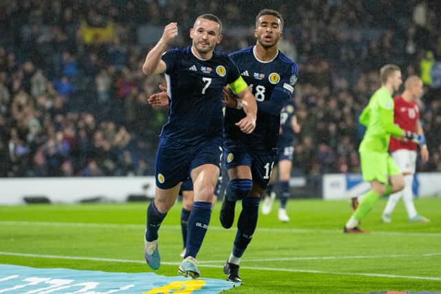 John McGinn and Jacob Brown celebrate a goal against Norway at Hampden, as Scotland took a step closer to Euro 2024 finals.