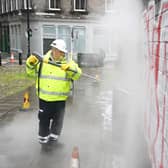 A council worker removing graffiti from a wall - the service could be expanded following the summit.