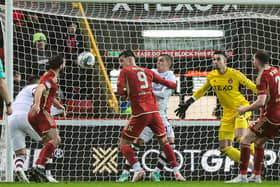 Lawrence Shankland scores past Kelle Roos at Pittodrie