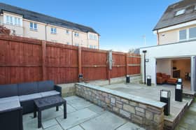 Outside, the home has a small front garden area and a split-level, enclosed rear garden. The latter benefits from a lawned area, and two paved patios. The property also benefits from two allocated parking spaces.