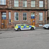 Police descended on Leith's Parliament Street after a woman was found dead