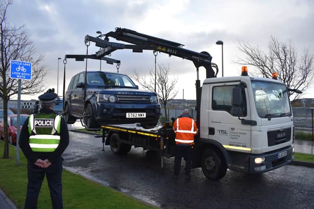 Police assist the DVLA with seizing an untaxed vehicles in Edinburgh. Picture: Kieran Murray.