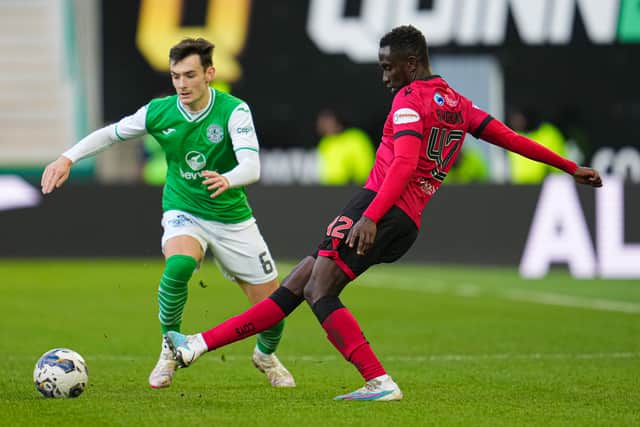 Dylan Levitt, seen here in a contest with Elvis Bwomono, was one of three Hibs players hooked at half-time.
