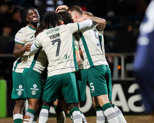 Surrounded by support: Miller is swamped by team-mates after making it 2-0 Hibs at Dens back in November.