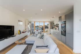 The open-plan kitchen, living, and dining room is the main reception room and is located on the third floor, illuminated by generous dual-aspect glazing, including wide patio doors affording access to two spacious terraces.