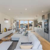 The open-plan kitchen, living, and dining room is the main reception room and is located on the third floor, illuminated by generous dual-aspect glazing, including wide patio doors affording access to two spacious terraces.