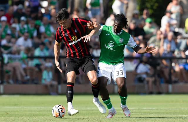 Joined at the hip. Hibs defender Rocky Bushiri and Bournemouth's Kieffer Moore in action during last July's pre-season friendly. How close are the two clubs now that Foley's bought two seats on the Easter Road board?