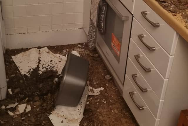The couple's kitchen was covered in debris after their ceiling 'collapsed', months after a leak was reported 