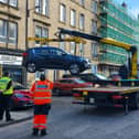 Vehicle lifted to be impounded on Brunswick Street in citywide crackdown