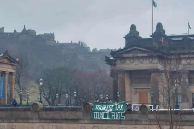 Living Rent members hung a banner outside the Scottish National Gallery demanding: "Tourist tax for council flats".