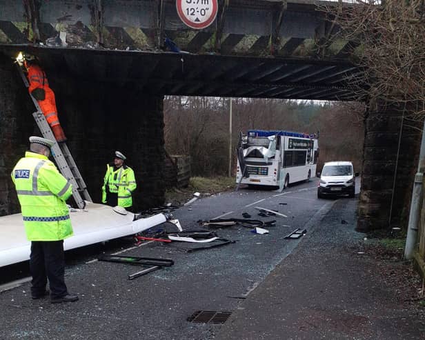 Roof of bus ripped off after it collides with low bridge in Fauldhouse. 