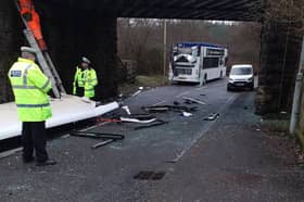 Roof of bus ripped off after it collides with low bridge in Fauldhouse. 