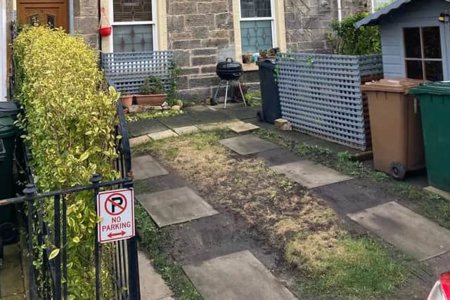 The order to rebuild the wall follows a three-year battle with the council over the driveway. 
