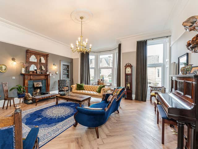 On the first floor, there is an impressive east facing living room with the bay window offering direct views to Arthur's Seat. This elegant room has grand high ceilings, intricate cornicing, open fire with surround, hardwood herringbone flooring, which also runs throughout much of this level with the luxury of no thresholds between rooms.