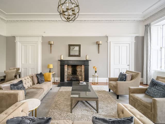 The generously proportioned lounge/dining room comes with dramatic high ceilings, ornate cornice work, wood flooring and attractive focal fireplace.