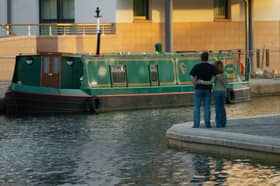 A couple look over the water to a Narrow boat at the Union Canal Basin at Fountainbridge in September 2004.