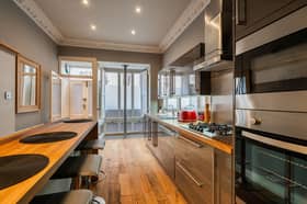 On the ground level, there is a modern kitchen with grey gloss units, mirrored splashback, integrated appliances and a breakfast bar that can seat up to four people for casual dining. The room has great character and features intricate cornicing and hardwood flooring which also runs throughout much of the property.