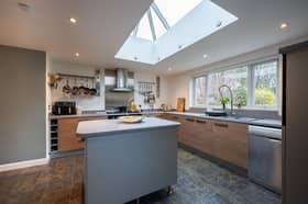 The kitchen/dining room has a modern fitted kitchen with integrated appliances, kitchen island and space for a large dining table.