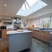 The kitchen/dining room has a modern fitted kitchen with integrated appliances, kitchen island and space for a large dining table.