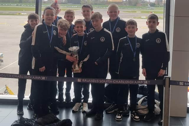 The Edinburgh City Academy 2012s at the airport with the Belgian Cup they won last weekend in a youth football tournament against teams for all over Europe.