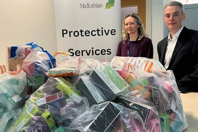 Gail McElroy who manages the council’s trading standards team and Councillor Stuart McKenzie with just some of the 2,300 illegal vapes seized from local retailers over the past year.