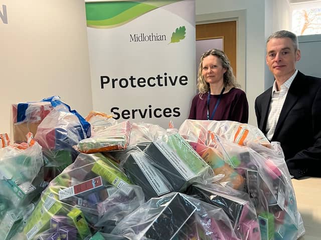 Gail McElroy who manages the council’s Trading Standards team and Councillor Stuart McKenzie with just some of the 2,300 illegal vapes seized from local retailers over the past year.