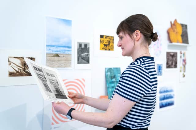Sales, gallery and archive assistant Elizabeth Jane Campbell helps to prepare the exhibition space at the Edinburgh Printmakers ahead of a new event 'Castle Mills: Then & Now, Whose Gallery is it Anyway?'.